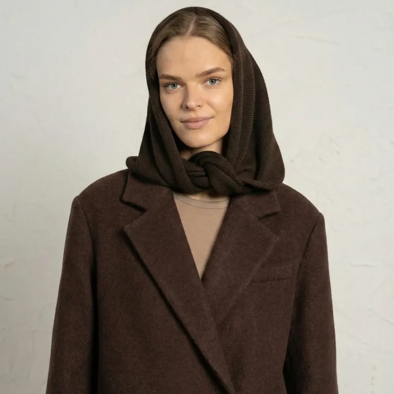 Close-up of woman wearing brown merino wool bandana styled as a hood scarf.